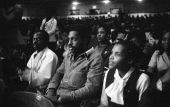 View showing audience in auditorium listening to civil rights speakers.