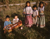 Seminole children with a toy wagon at the Brighton Indian Reservation.