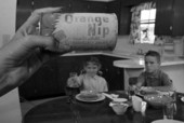 View showing a can of Orange Nip frozen orange juice with eager children waiting in the background - Sarasota, Florida.