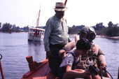 Tourist taking instant photo with sponge diver during diving exhibition in Tarpon Springs.