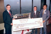 Akio Makiyama, Chairman of Maglev Transit, Inc (right)presents a check to Governor Bob Martinez (left) and Chairman Malcolm Kirschenbaum (center right) - Tallahassee, Florida.