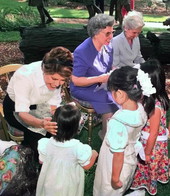 Florida first lady Columba Bush, left, joins former first ladies Donna Lou Askew, center, and Rhea Chiles in greeting children during a Governor's Mansion ceremony..