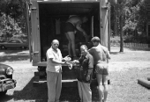 Universal International crew holding up film footage on the set of "Revenge of the Creature" movie.