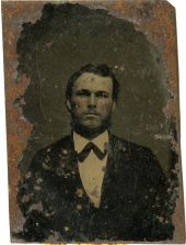 Hand-tinted portrait of a bearded man.