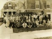 Group portrait of Rotarians in front of the Lake Court Apartments.