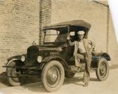 Luther W. Coleman standing with his Chevrolet in St. Petersburg.