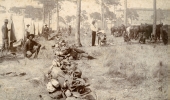 Barber at work in camp during the Spanish-American War.