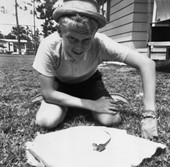 Chip Bloyd with baby alligator bought at Silver Springs, in his yard in Panama City.