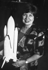 JoAnn Hardin Morgan, posing with space shuttle model