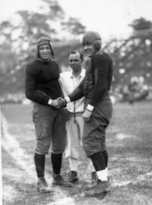 University of Miami football player shaking opponent's hand.