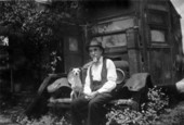 Retired railroad man sitting on the bumper of his house-car