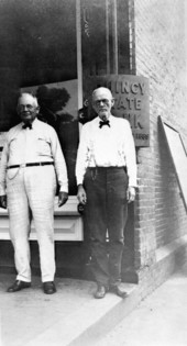 E. B. Shelfer, Sr. (left) and "Pat" Munroe at Quincy State Bank corner