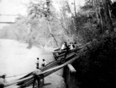 Passengers and baggage on railroad cart to steamship