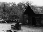 Construction on a log house near the smokehouse