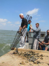 Governor Charlie Crist preparing to tong for oysters in Apalachicola Bay.