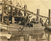 Oyster fishermen on a boat in dock at Apalachicola, Florida.