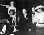 Florida Governor Farris Bryant poses with employees of the Six Gun Territory theme park at the Florida State Fair.