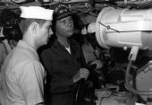 Florida Governor Bob Graham manning the helm of an aircraft carrier