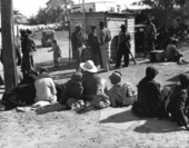 Migrant workers waiting for a truck to take them to the bean fields - Lake Harbor, Florida.