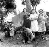 Migrant agricultural worker and his family - Canal Point, Florida.