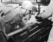 Gun crew loading and sighting 105 mm field piece at Camp Blanding - Starke, Florida