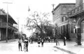 People stand on the intersection of 14th Street and 9th Avenue in Ybor City - Tampa, Florida.