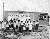 Beach-goers assembled for a group portrait by the bath house at Butler Beach - Anastasia Island, Florida.