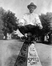 "Mac" Malcolm Daniel McCoy seated on a speed limit sign - Tallahassee, Florida.