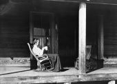 Henriette Martens sitting in a rocking chair on the porch of her home - Miami, Florida.