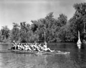 Wakulla Springs' visitors enjoying the ride down river aboard the seatless "alligator boat"