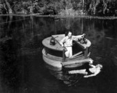 Cameraman Russ Erving standing in underwater filming bell at Wakulla Springs.