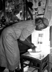 Midwife washing her hands prior to examining patient