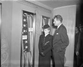 Governor Millard F. Caldwell viewing flag display with Martha Thornton Thomas.