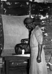 Midwife putting her bag on newspaper in the home of a patient.