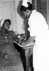 Expectant mother having her blood pressure taken by a registered nurse in Leon County, Florida.