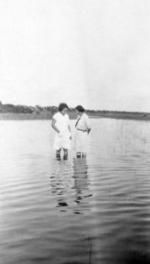 Midwife instructor Julia Graves, right, standing in the water with another woman.