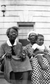 Nurse McGreen with another woman holding a baby during the West Florida Midwives Institute at Florida A&M College in Tallahassee, Florida.