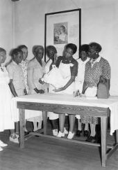 Leon County Health Dept. nurse Lillie Mae Chavis showing midwives how to use a portable scale to weigh babies.