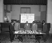 Arlin Aldrich, Assistant Director for the State Civil Defense, looking over model with group of unidentified men - Jacksonville, Florida.