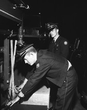 Tallahassee firefighters Bernard "Bernie" Kemp and Kenneth "Ray" Holley conducting fire apparatus equipment check.