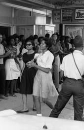 Patricia Stephens Due, foreground in black dress, picketing with others at the State Theatre in Tallahassee.