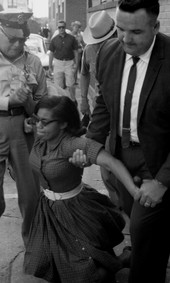 Patricia Stephens Due being arrested after defying restraining order with others at the State Theatre in Tallahassee.