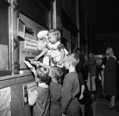 Children with Santa mailing letters to Santa from Tallahassee.