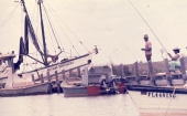 African American people fishing from the docks on St. George Island in Franklin County, Florida.