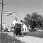 Al and Roey Stickles pushing a baby stroller through a trailer park in Sarasota, Florida.