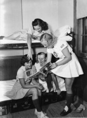 All American Girls Professional Baseball League members looking at a magazine - Opa-locka, Florida