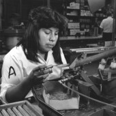 Seminole Indian woman assembling connectors.