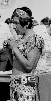 Mikasuki Indian in ethnic costume playing a flute at a festival in Florida.