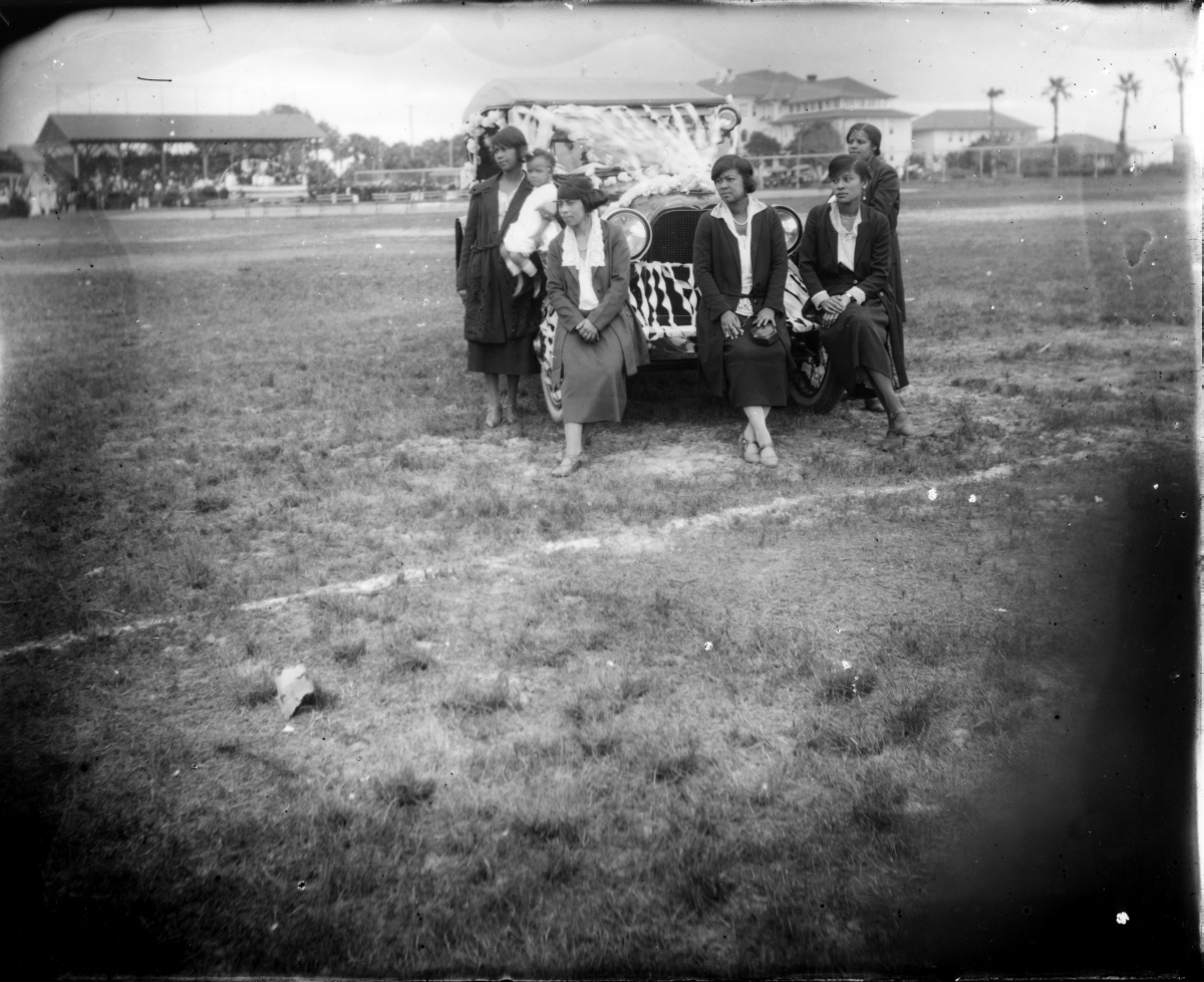 African-American women stand in front of a car decorated for an Emancipation Day parade in Lincolnville (circa 1925).