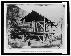James Marshall standing in front of Sutter's Sawmill.